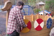 Jason from GalGael adding shields to the boat
